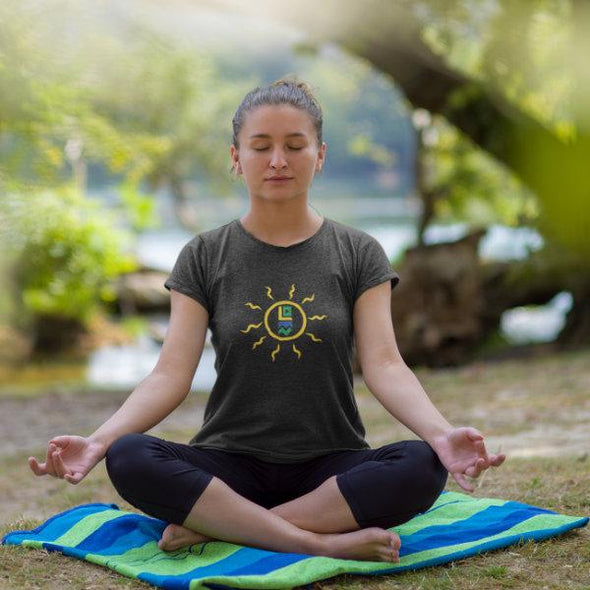 Woman sitting on towel meditating wearing Less Drama More Nature Sun Signs T-shirt